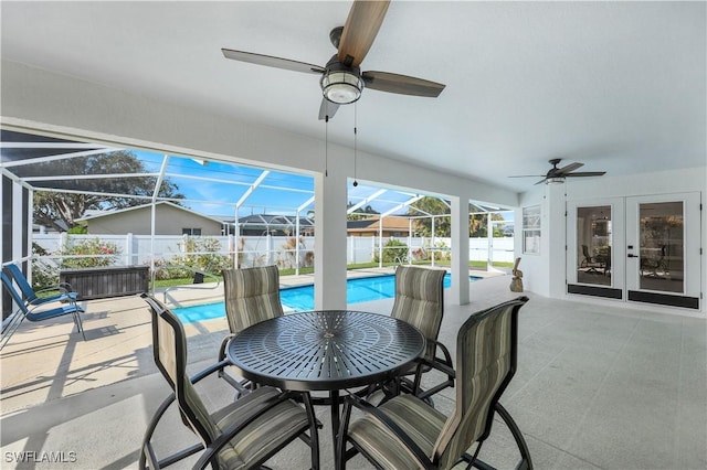 view of patio / terrace with french doors, ceiling fan, a fenced in pool, and glass enclosure