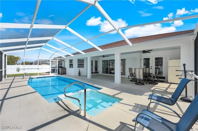 view of swimming pool featuring a lanai, a patio area, french doors, and ceiling fan