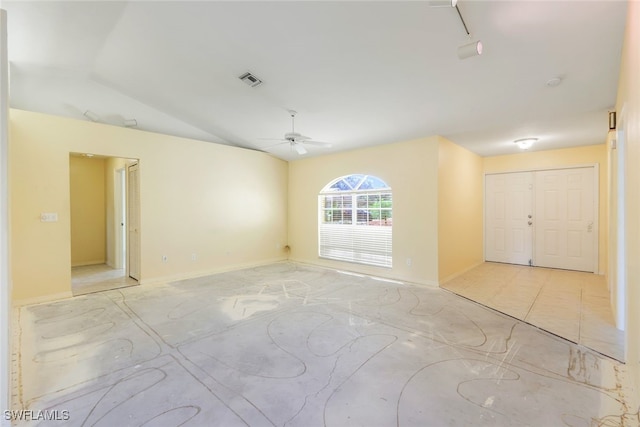 empty room featuring lofted ceiling and ceiling fan