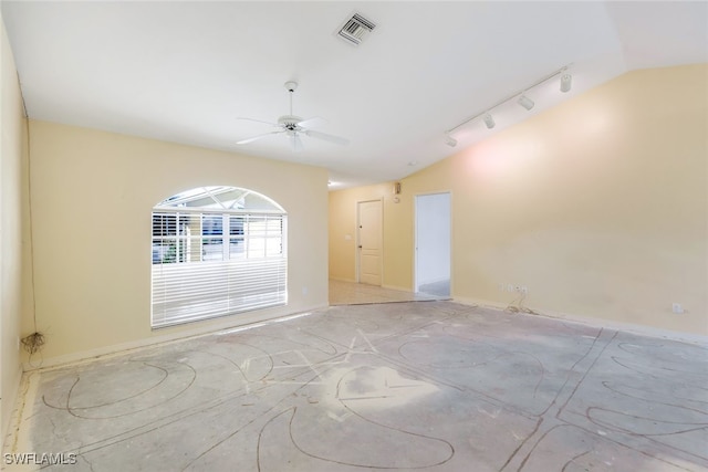 spare room with vaulted ceiling, track lighting, and ceiling fan