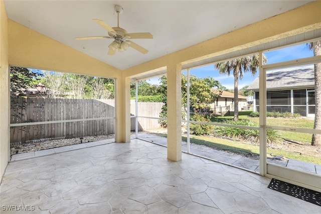 unfurnished sunroom featuring lofted ceiling and ceiling fan