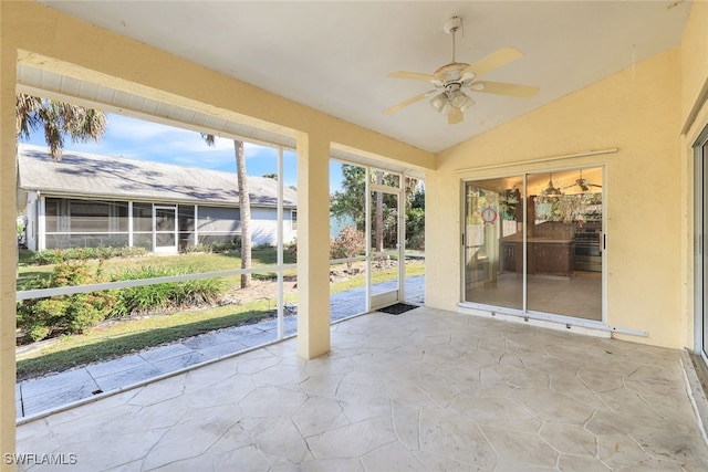 unfurnished sunroom featuring lofted ceiling and ceiling fan