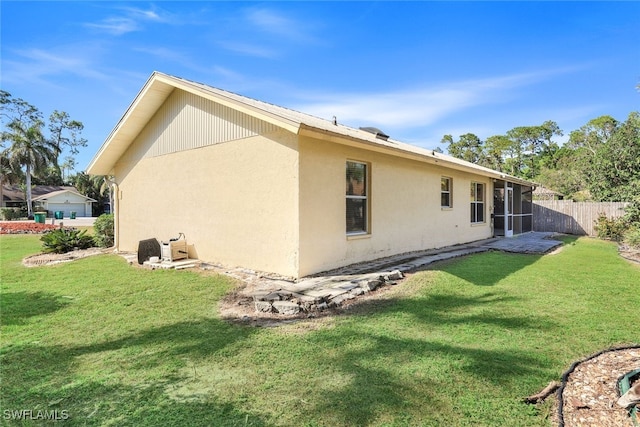 rear view of house with a yard