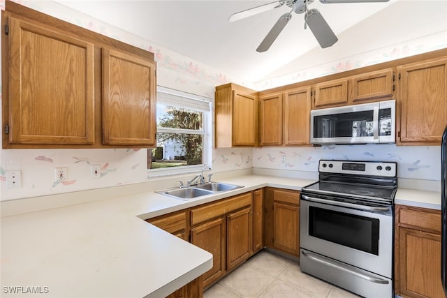 kitchen with lofted ceiling, sink, stainless steel appliances, and ceiling fan