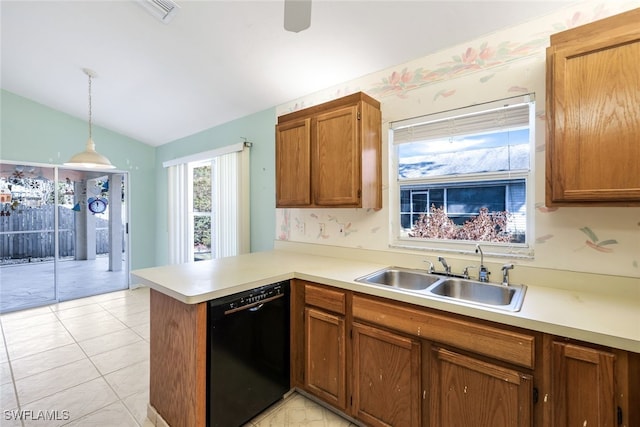 kitchen featuring vaulted ceiling, decorative light fixtures, black dishwasher, sink, and kitchen peninsula