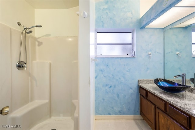 bathroom with a shower, tile patterned floors, and vanity