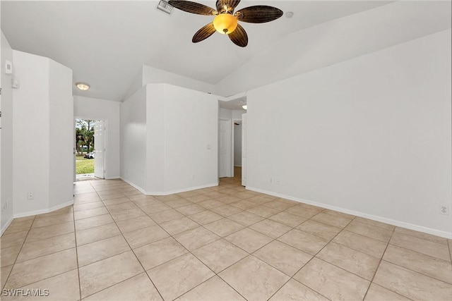 tiled empty room with ceiling fan and vaulted ceiling