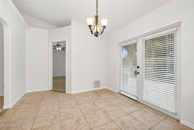 tiled empty room with ceiling fan with notable chandelier