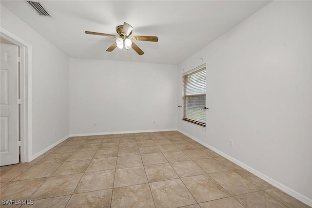 empty room featuring light tile patterned flooring and ceiling fan