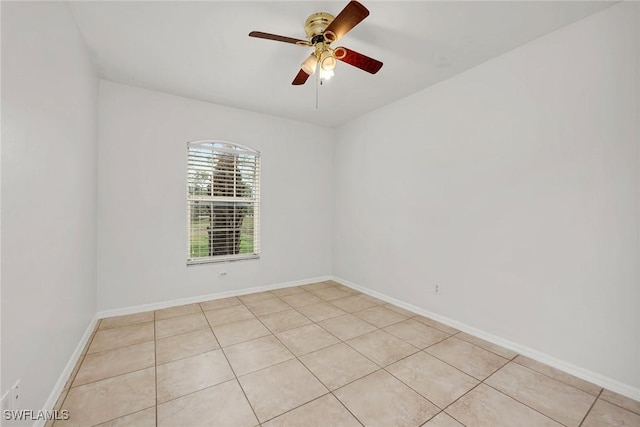 tiled empty room featuring ceiling fan