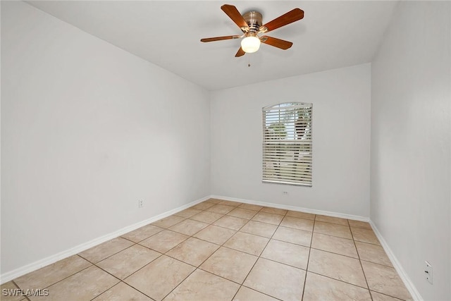 tiled spare room featuring ceiling fan