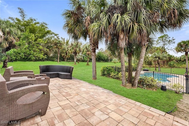 view of patio with a fenced in pool and outdoor lounge area