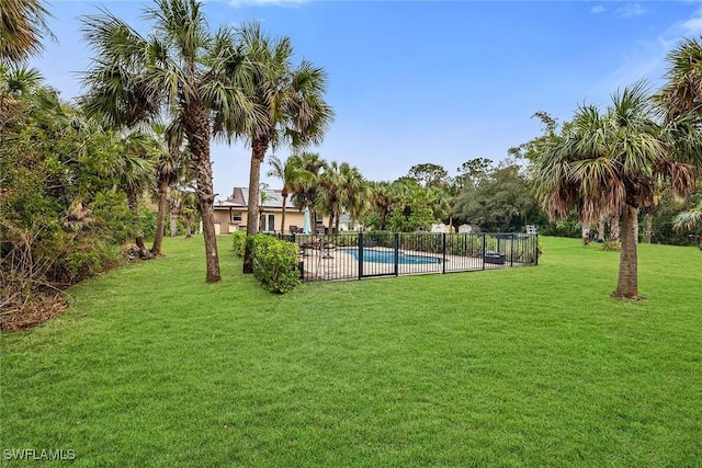 view of community featuring a pool and a yard