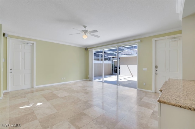 interior space with a textured ceiling, ornamental molding, and ceiling fan