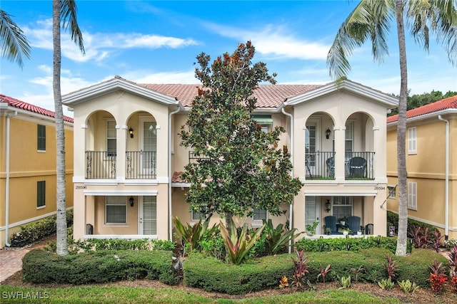 mediterranean / spanish house featuring a balcony