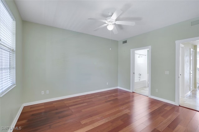 spare room featuring ceiling fan and dark hardwood / wood-style flooring