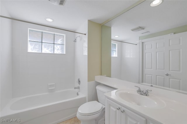 full bathroom featuring tile patterned floors, vanity, toilet, and tiled shower / bath combo