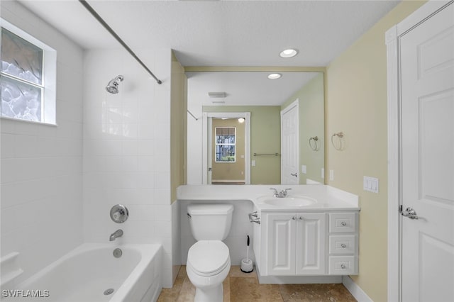 full bathroom with tiled shower / bath, a wealth of natural light, vanity, and toilet