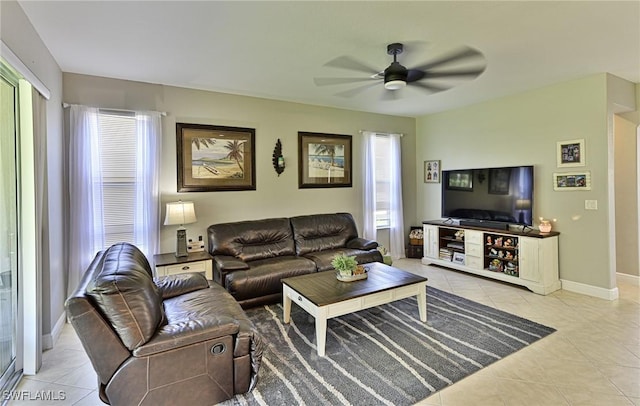 living room with light tile patterned floors, a healthy amount of sunlight, and ceiling fan