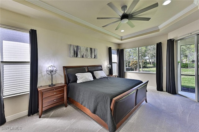 bedroom with crown molding, ceiling fan, a raised ceiling, and light carpet