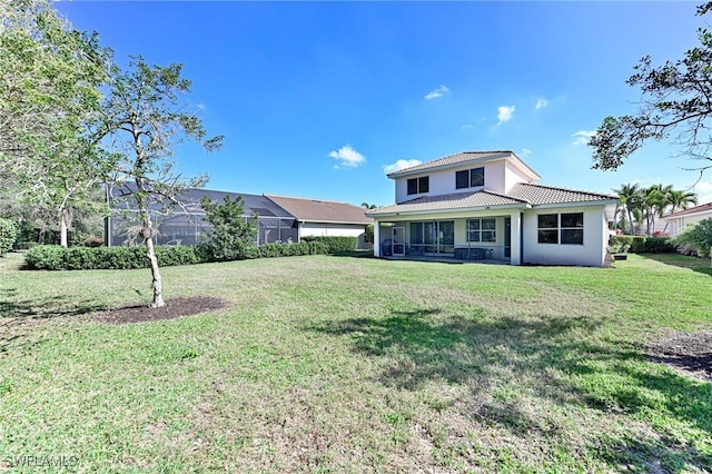 rear view of property featuring a yard