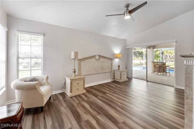 sitting room featuring dark wood-type flooring, plenty of natural light, ceiling fan, and vaulted ceiling