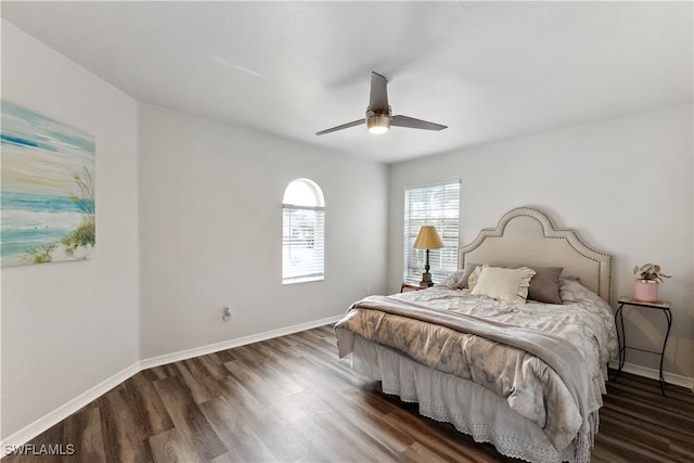 bedroom with ceiling fan and dark hardwood / wood-style flooring