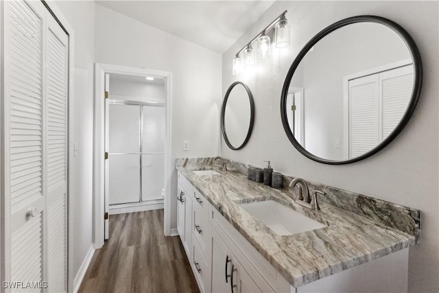 bathroom featuring lofted ceiling, toilet, a shower with shower door, vanity, and hardwood / wood-style flooring