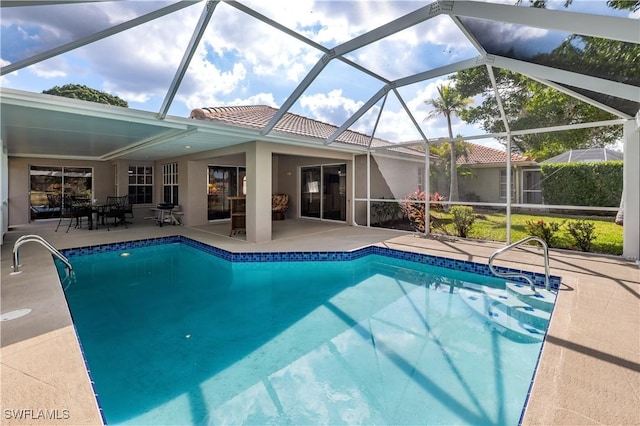 view of swimming pool with a patio area and glass enclosure