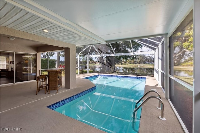 view of pool with a lanai, a patio, and a water view