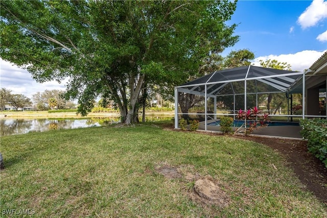 view of yard featuring a water view and glass enclosure