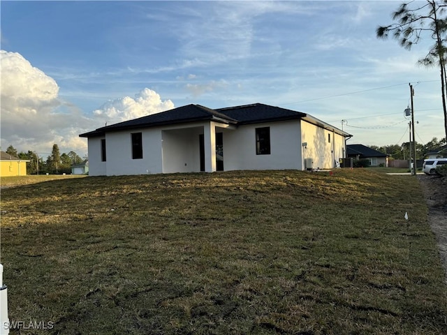 rear view of property with a lawn