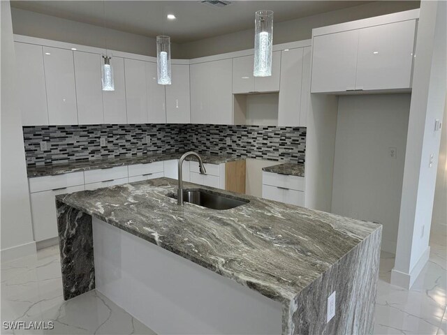 kitchen with marble finish floor, modern cabinets, and a sink