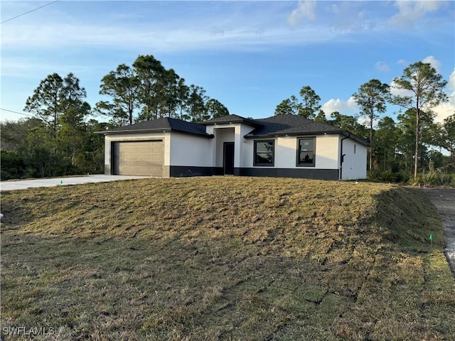 view of front of home featuring a garage and a front lawn