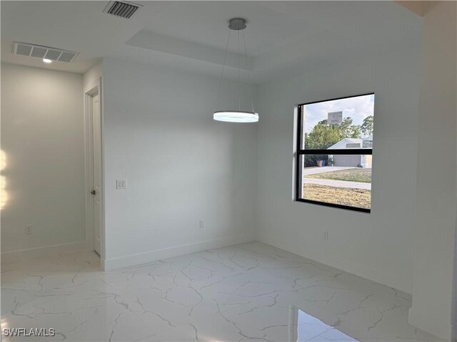 unfurnished room with baseboards, visible vents, and marble finish floor