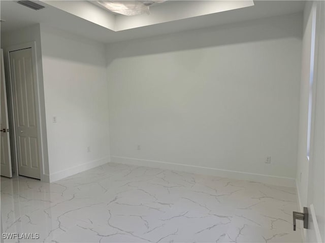 empty room featuring visible vents, marble finish floor, and baseboards