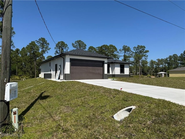 view of front of property with stucco siding, a front lawn, driveway, cooling unit, and an attached garage