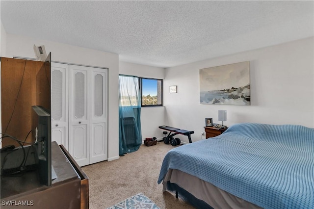 carpeted bedroom with a textured ceiling and a closet