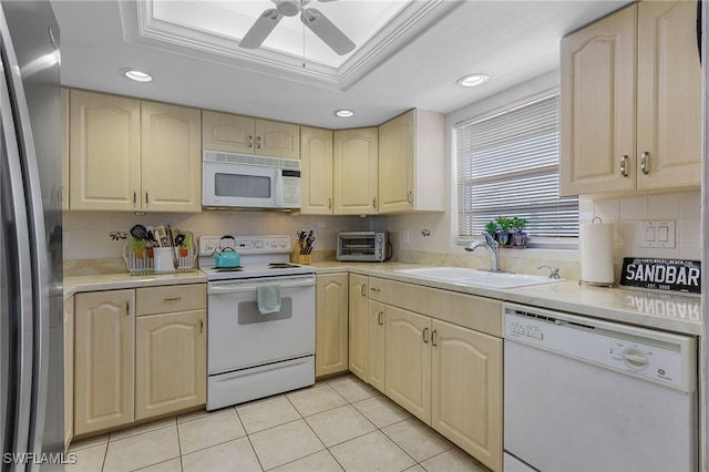 kitchen with light tile patterned flooring, sink, tasteful backsplash, a raised ceiling, and white appliances