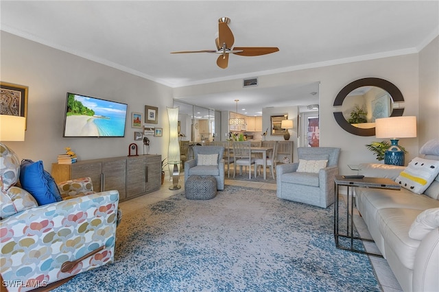 tiled living room with crown molding and ceiling fan