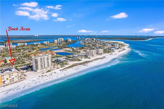 drone / aerial view with a beach view and a water view