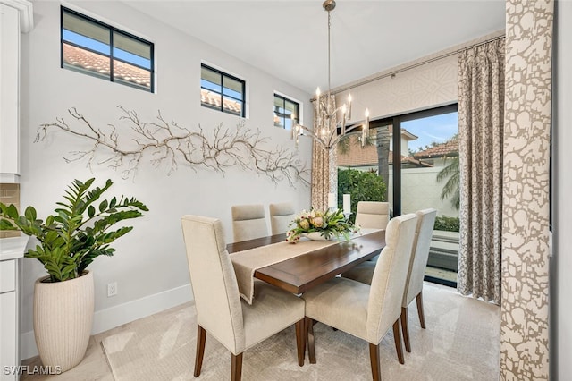 dining area with a notable chandelier, a healthy amount of sunlight, and baseboards