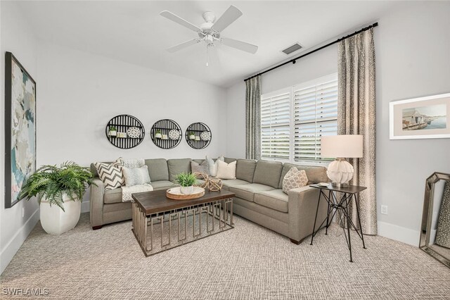 living room featuring light colored carpet and ceiling fan