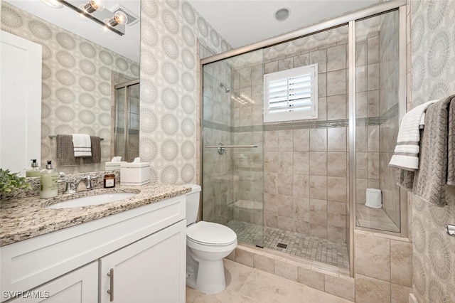 full bathroom with toilet, wallpapered walls, a shower stall, tile patterned flooring, and vanity