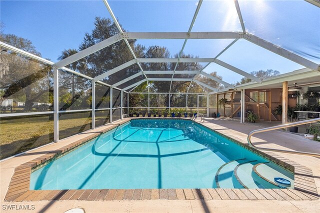 view of swimming pool with a patio area and glass enclosure