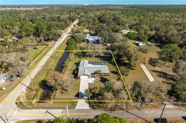 birds eye view of property with a view of trees