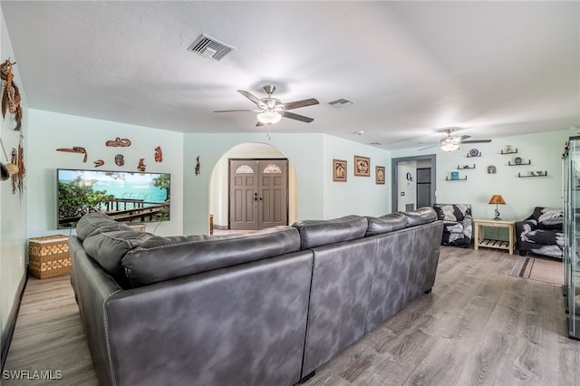 living room with ceiling fan and light wood-type flooring