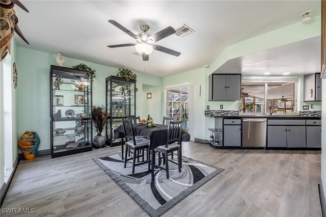 dining area with light wood-type flooring, baseboards, visible vents, and a ceiling fan