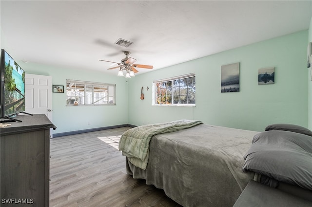 bedroom with ceiling fan and light wood-type flooring