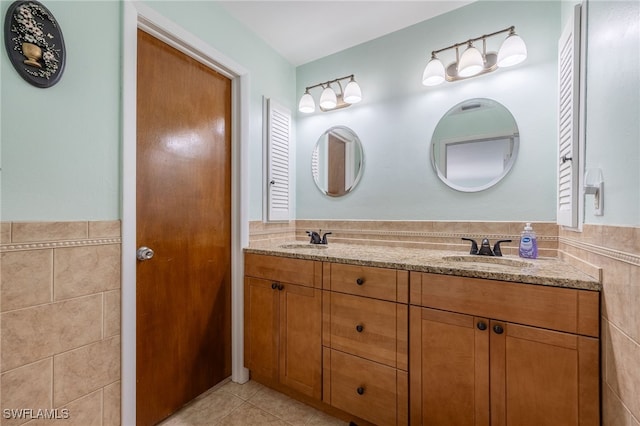 bathroom featuring vanity, tile patterned flooring, and tile walls